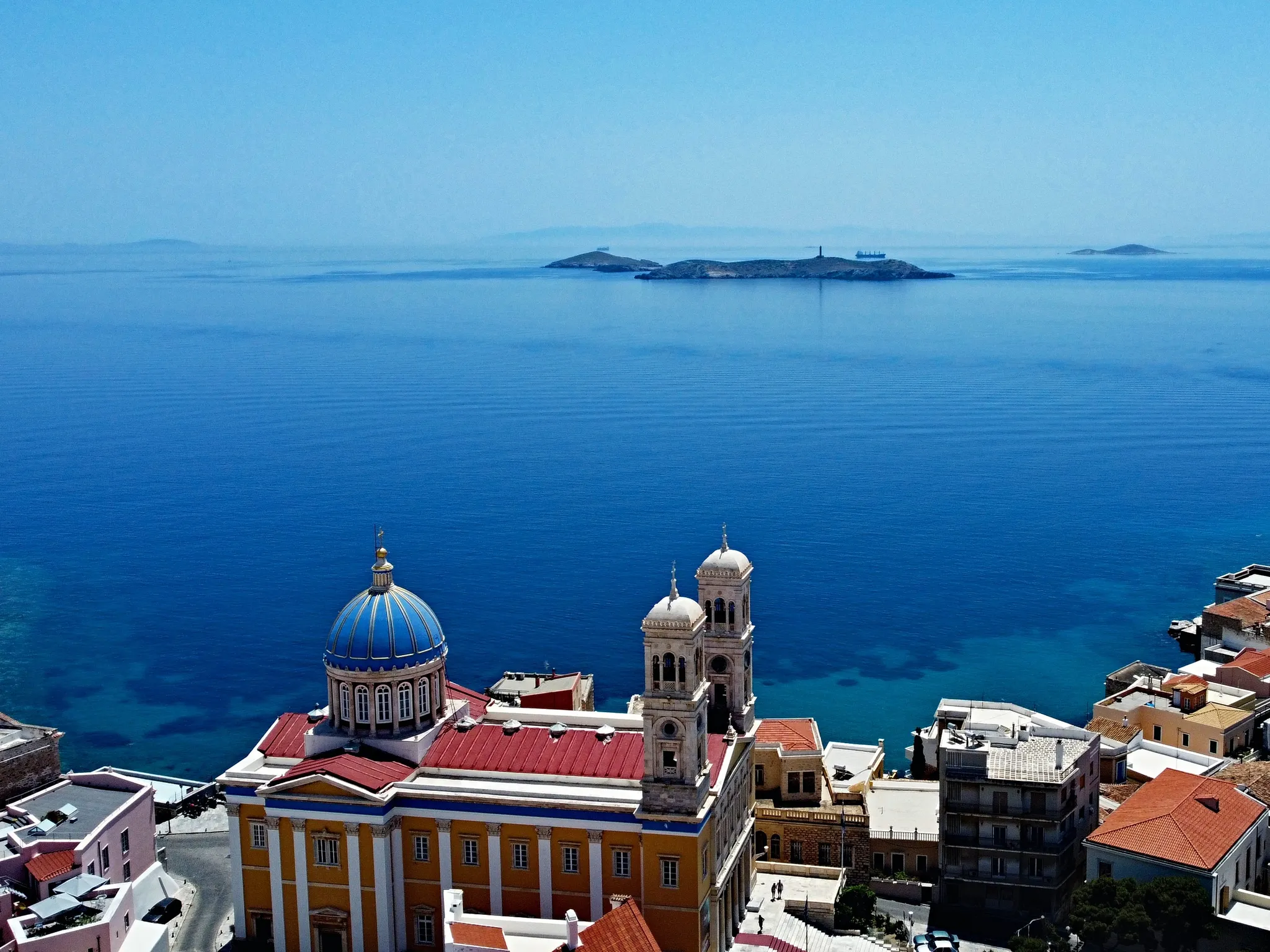 Vaporia in Ermoupoli: neoclassical mansions above the sea and the blue dome of Agios Nikolaos