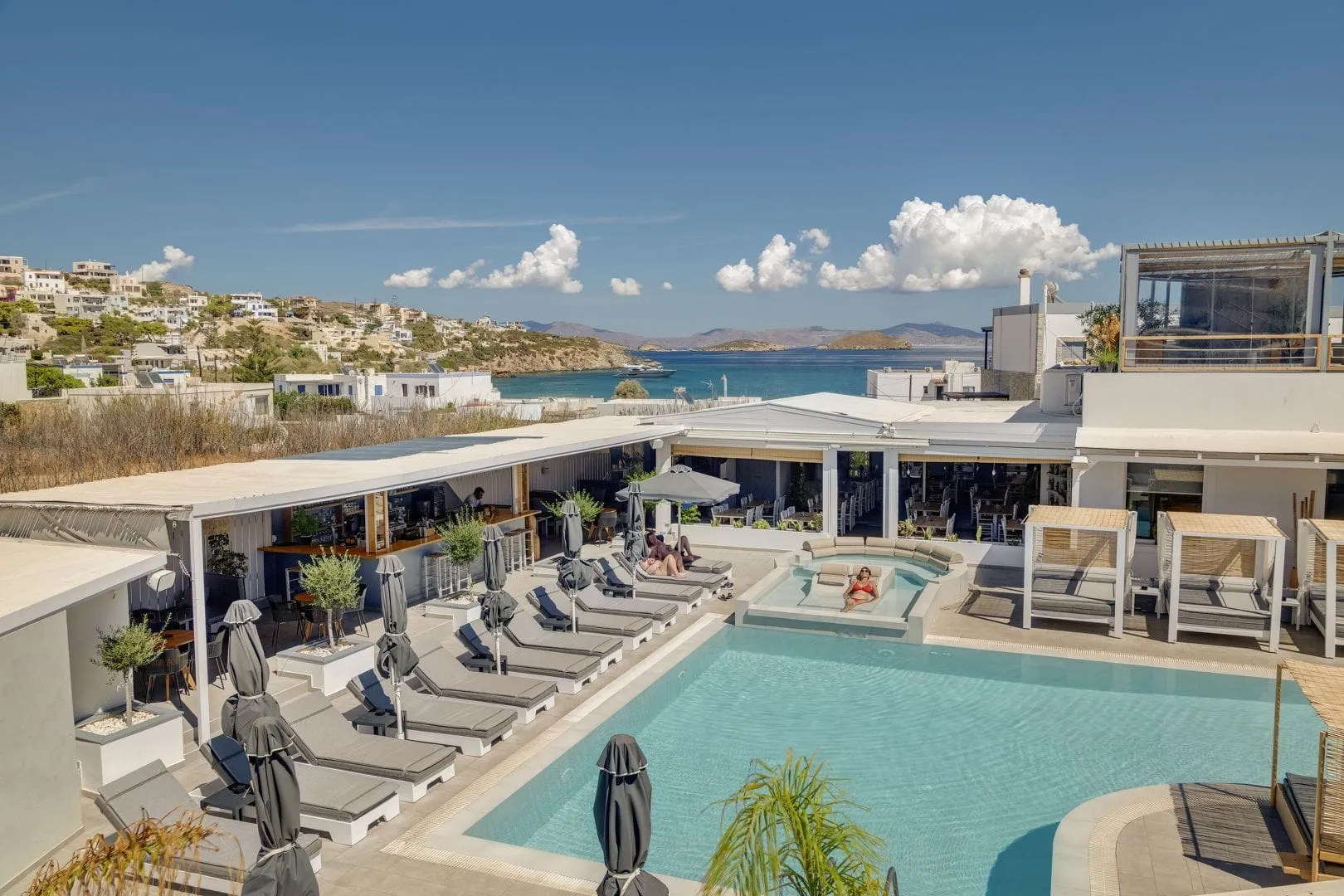 The pool at Aegean Paradiso from above, with the bay of Azolimnos beyond